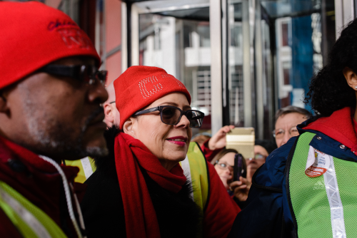 Union marshals escorted CTU President Karen Lewis away from the rally stage after her speech, Luke White