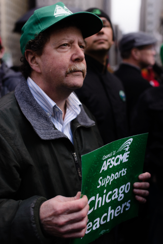 A union member at AFSCME (the American Federation of State, County and Municipal Employees) carried a sign showing his union’s solidarity with the CTU, Luke White