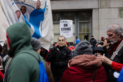 A man in a Rahm Emanuel mask said he wore the mask to protest the mayor’s 2013 school closings; other protestors marched to demand more investment in neighborhood public schools, Luke White