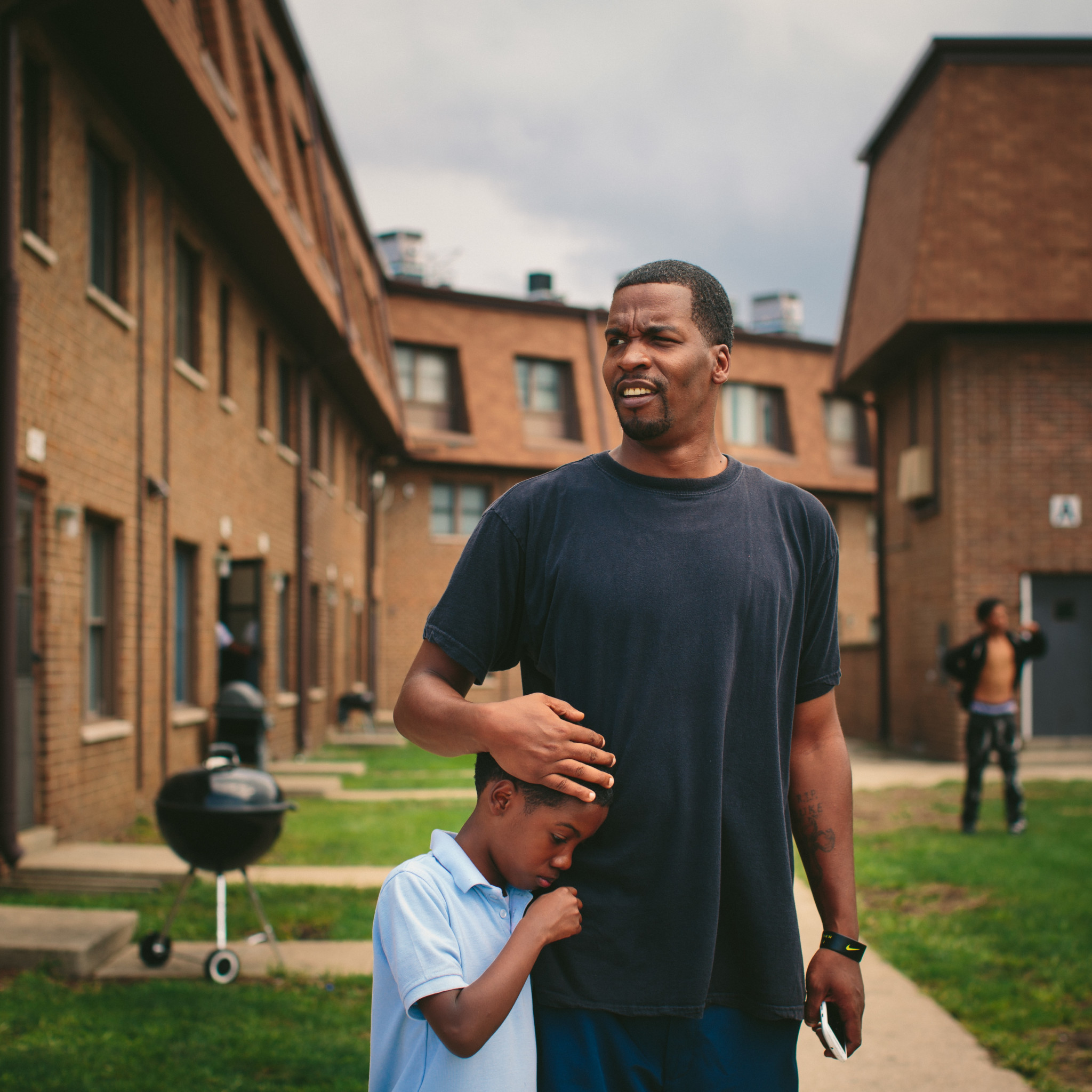 Lamont Anderson embraces his son Lamont Anderson Jr., 8, at the West Calumet Housing Complex. Anderson Jr.'s blood lead levels test results were above the CDCs 5 mg/d threshold for action. After living in the complex for more than a decade, the family moved to Gary, Indiana earlier this summer.