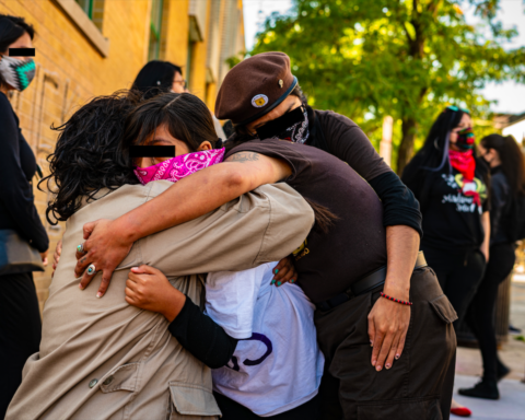 Protesters embraced following the violence. Photo by Óscar Sánchez.