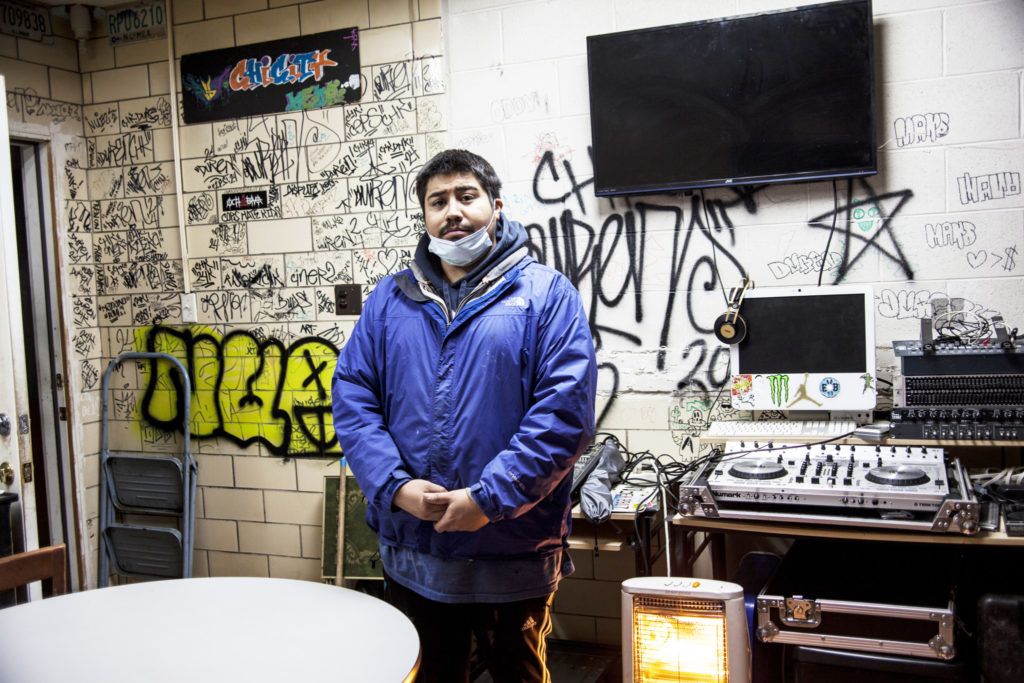 Tenant Juan Gonzalez stands in his living space and home studio. “This is where I help people with their ambitions, their music and their art.”