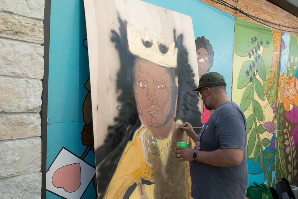 Painter working on the mural at the DuSable