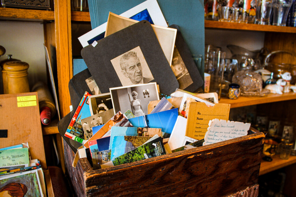Alex Orozco, owner and wife of Francisco Orozco, says that her husband began collecting antique items at a young age. Here is a collection of post- cards and photos. Credit: Hillary Flores/ South Side Weekly