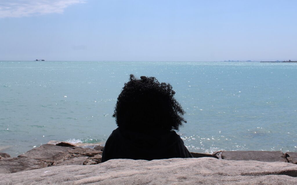 Connie Lowery rests while looking out over Lake Michigan at Promontory Point.